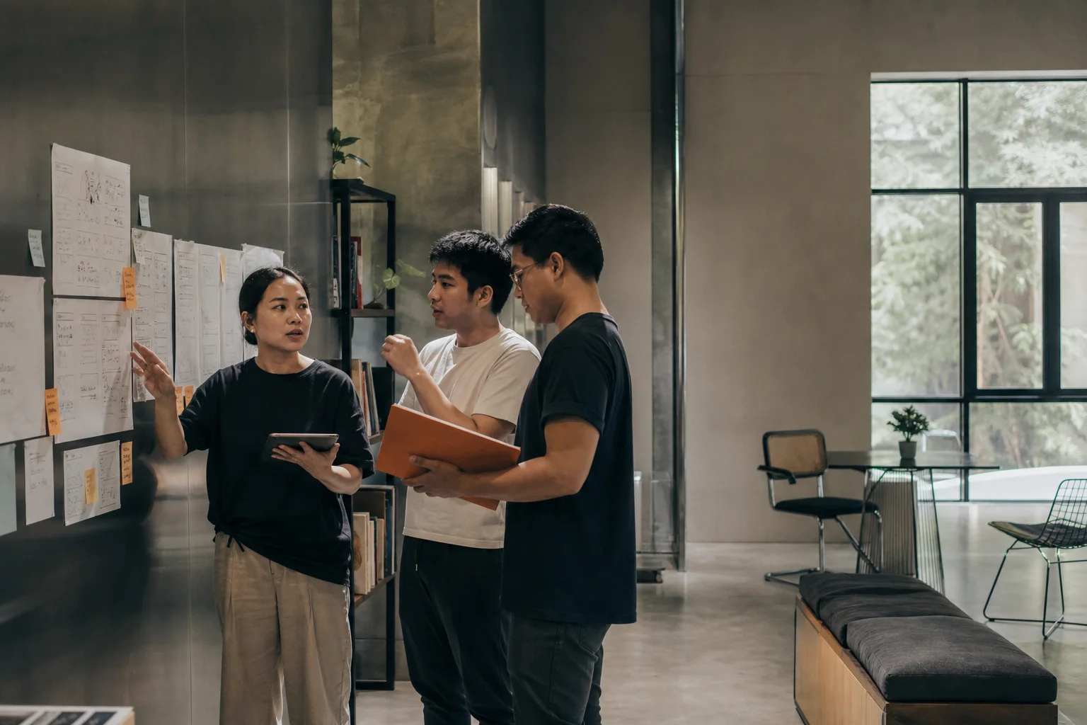 An industry expert discussing product decisions with two learners