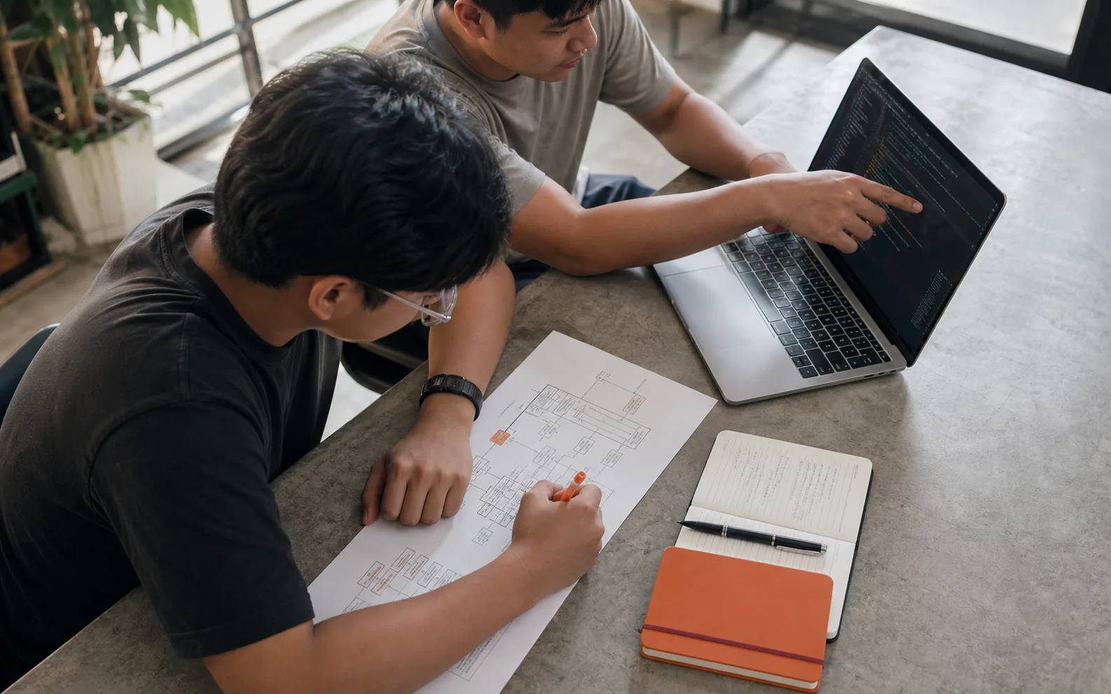 Software engineers reviewing product architecture and code together